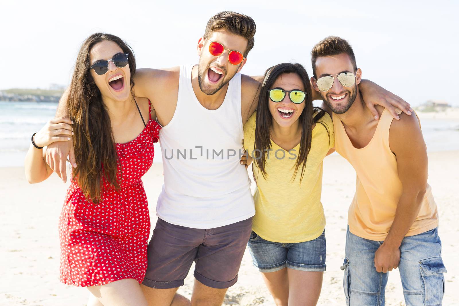 Group of friends having fun at the beach