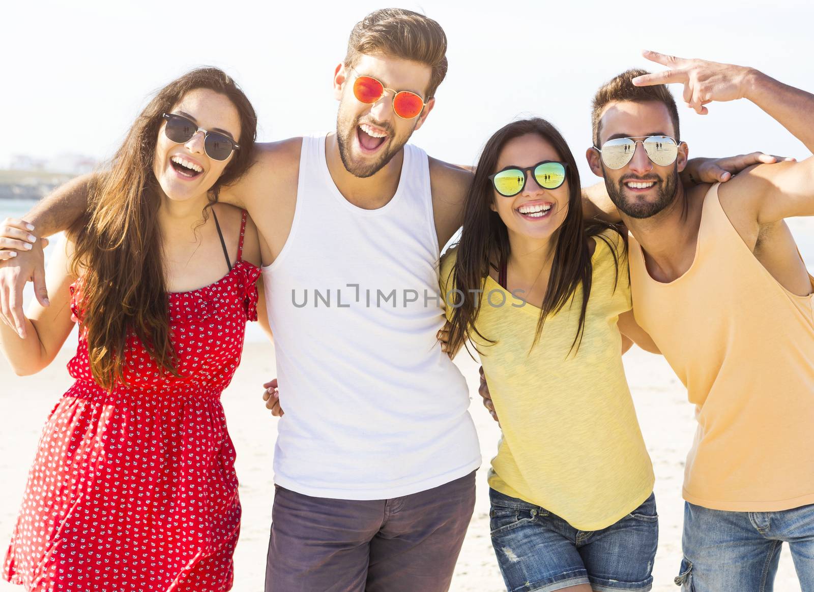 Group of friends having fun at the beach