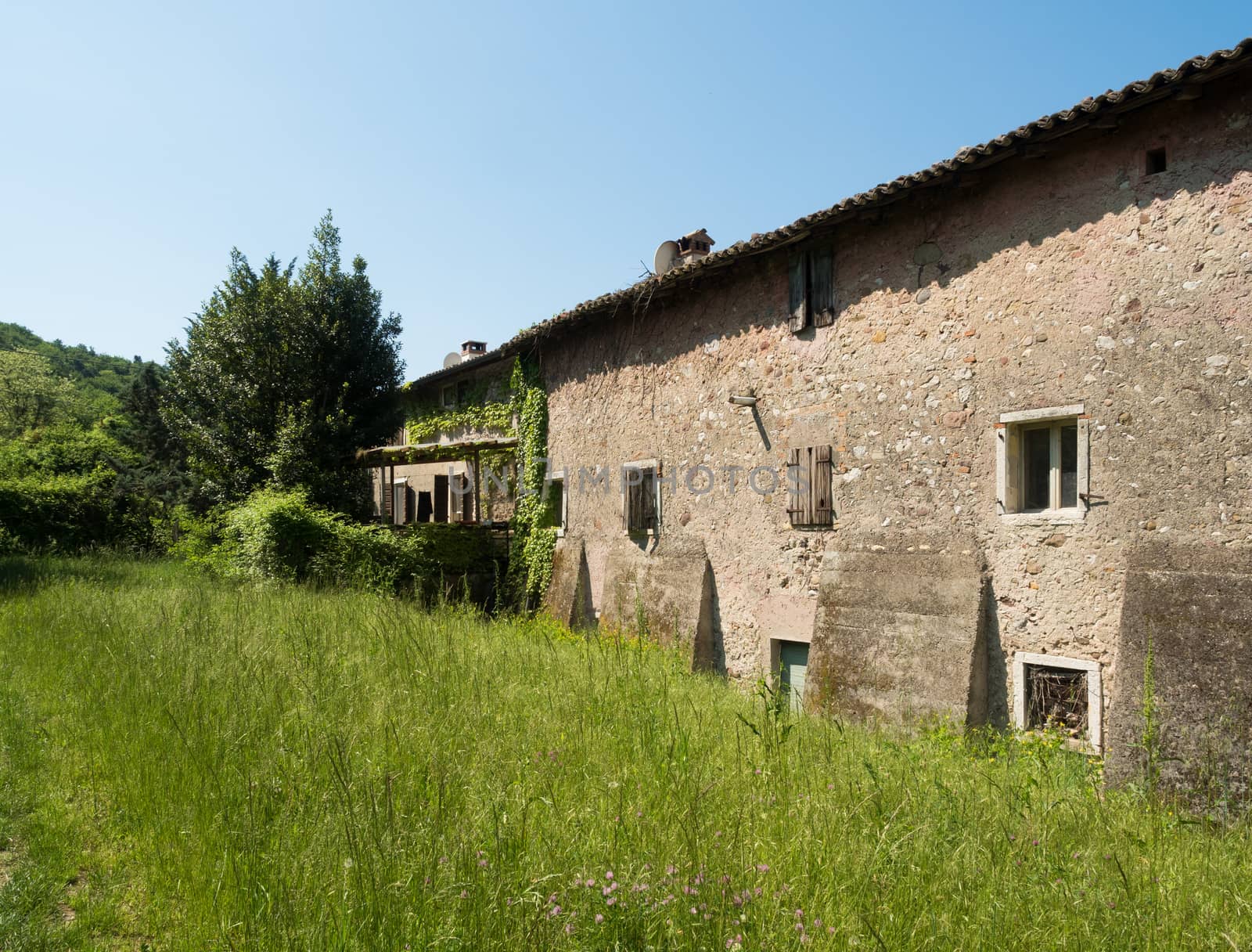 Old abandoned stone house in the Italian hills.