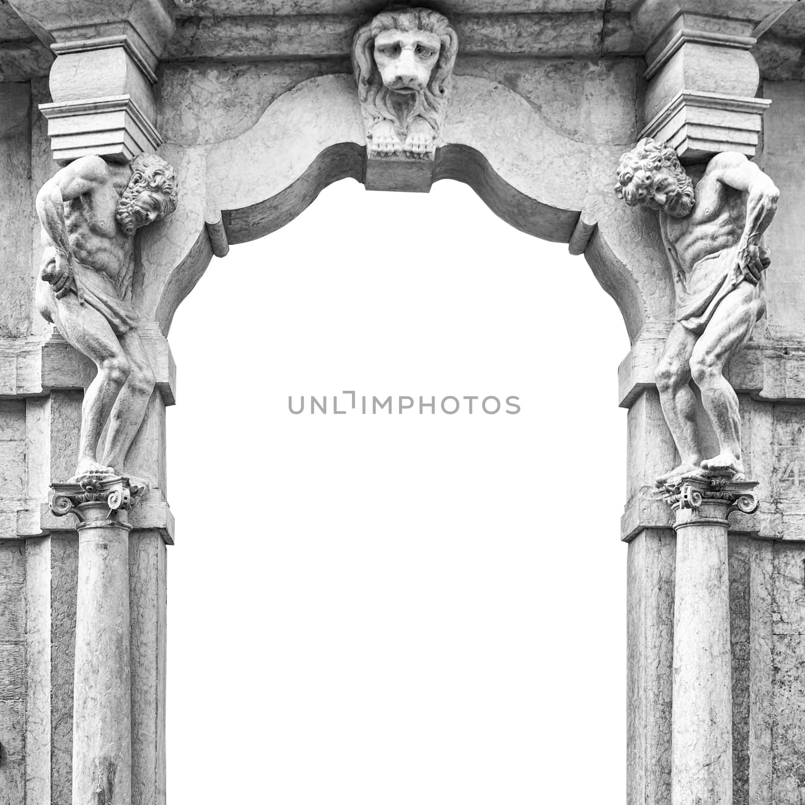 Old white stone entrance with statues that support the side columns.