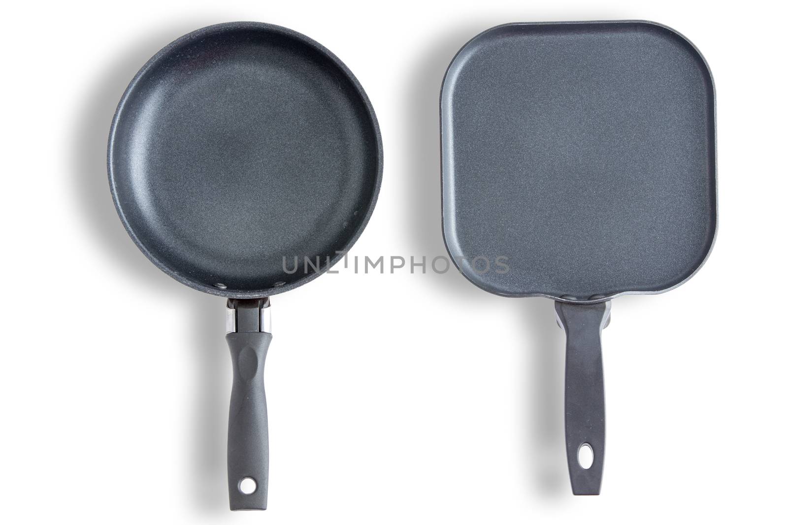 Two round and square with chamfered corners clean pans or skillets on a white background arranged side by side and viewed from above in a cookery concept