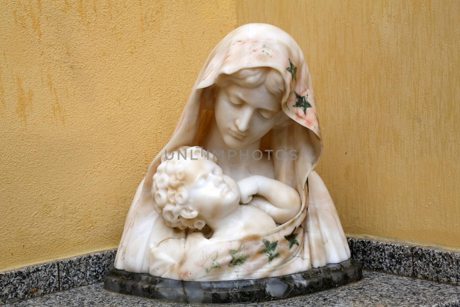 The statue of Madonna with the Child in front of the Church of the Holy Sacrament in Portoferraio, Elba, Italy