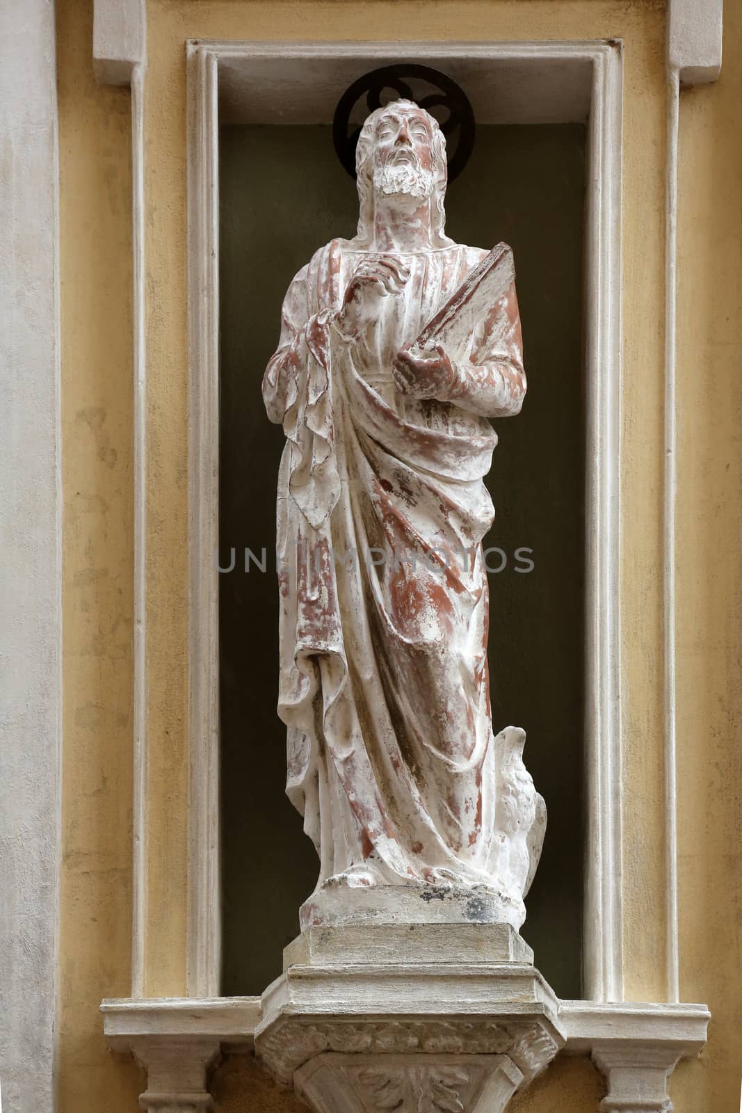 St. John the Evangelist on the facade of the Church of Mercy in Portoferraio, Elba, Italy