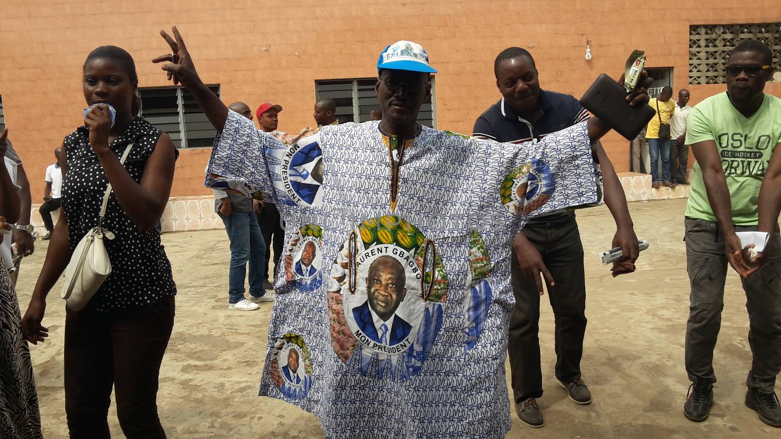 IVORY COAST, Abidjan : Supporters of former Ivorian president Laurent Gbagbo gestures after attending a live broadcast of his trial in front of the International Criminal Court (ICC) in The Hague, on January 29, 2016 in Yopougon district,  his former fiefdom in Abidjan.The high-profile trial of former Ivorian president Laurent Gbagbo opened today five years after post-election violence wracked his nation, with supporters and foes aiming to shed light on the turmoil that left 3,000 dead.
