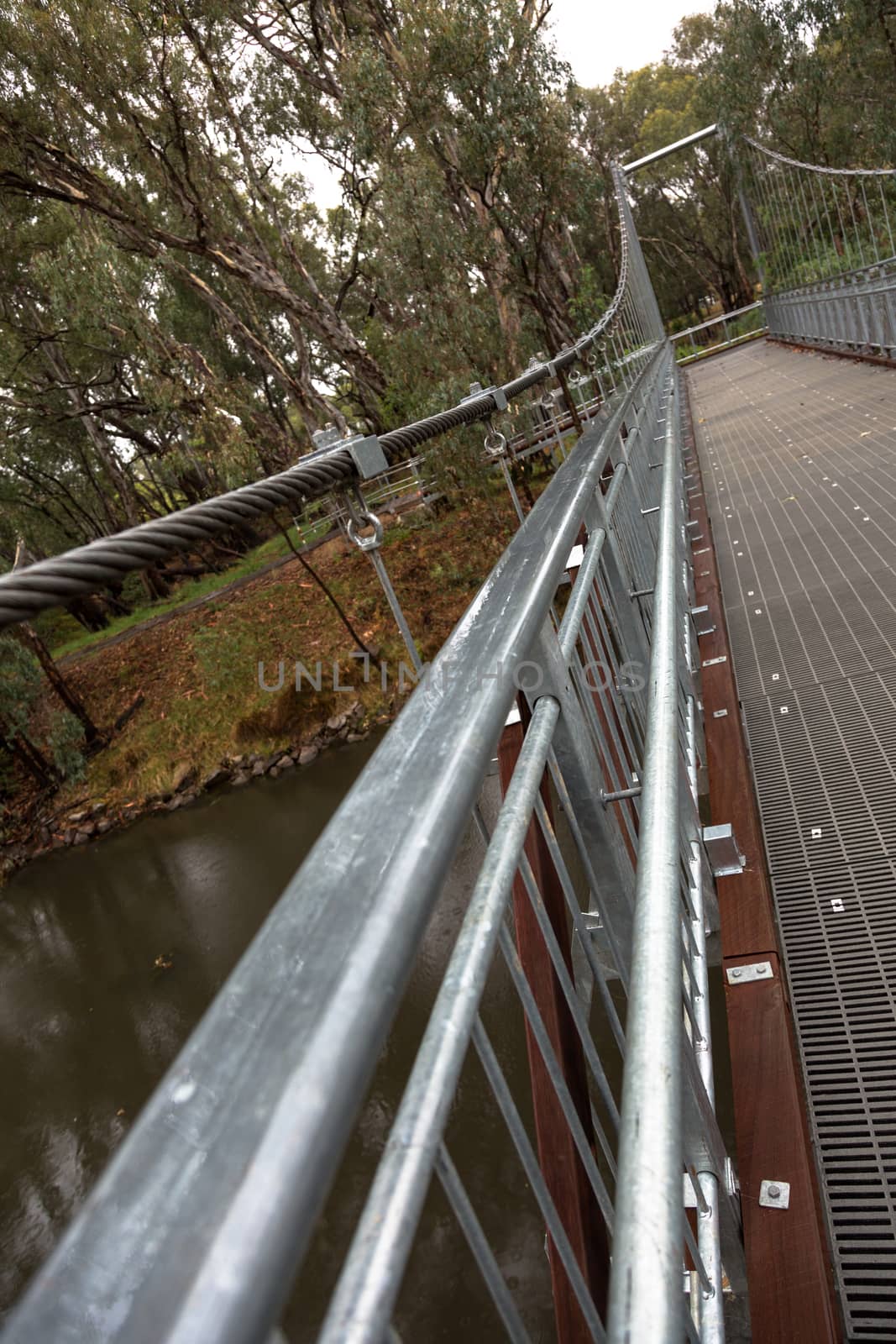 Steel Suspension footbridge over river by davidhewison