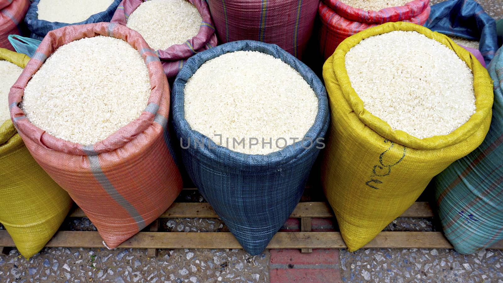 Rice in colorful pastel sack at fresh local market  in Luang Prabang, Laos