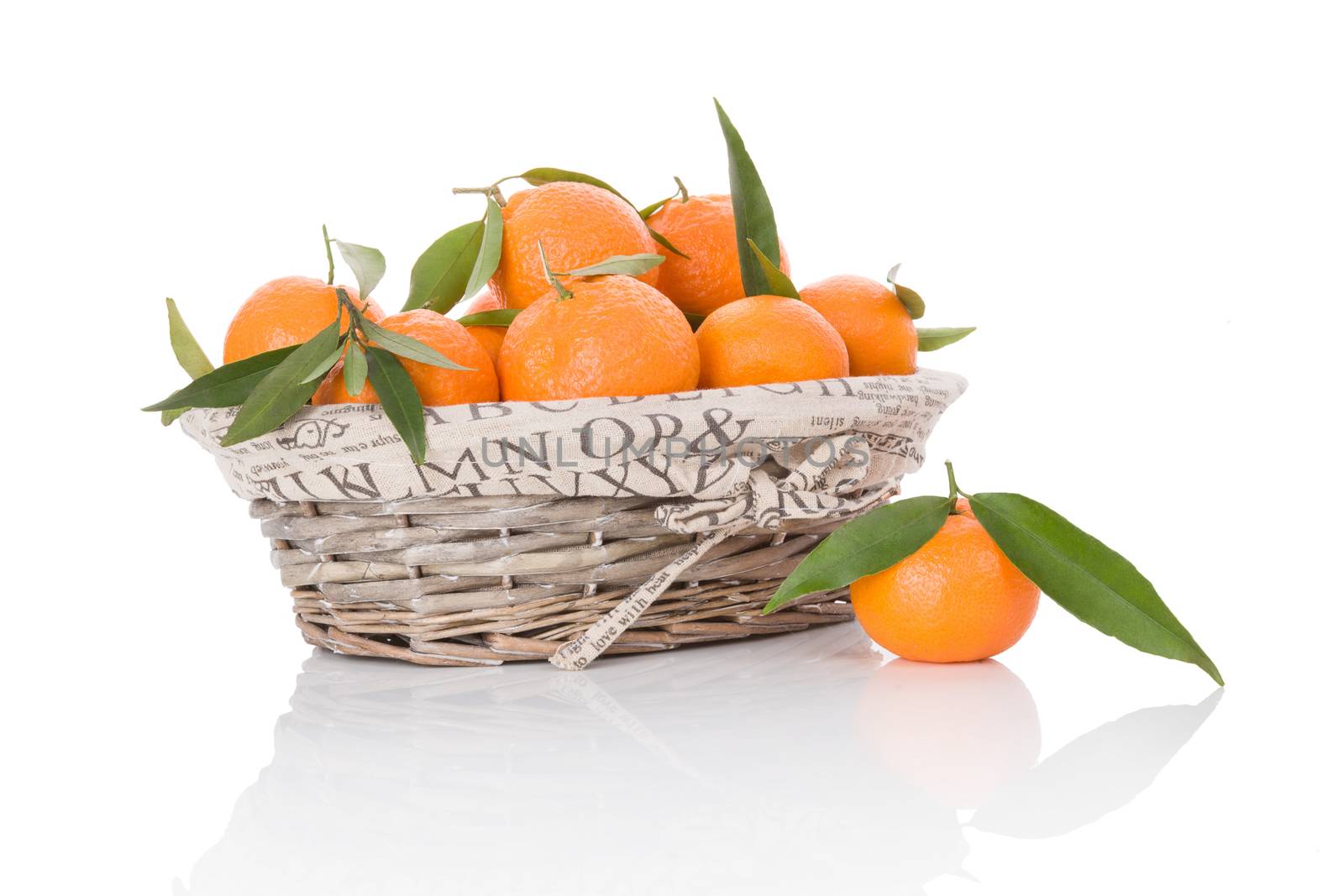 Mandarines in white wooden basket isolated on white background. Fresh ripe fruit background.