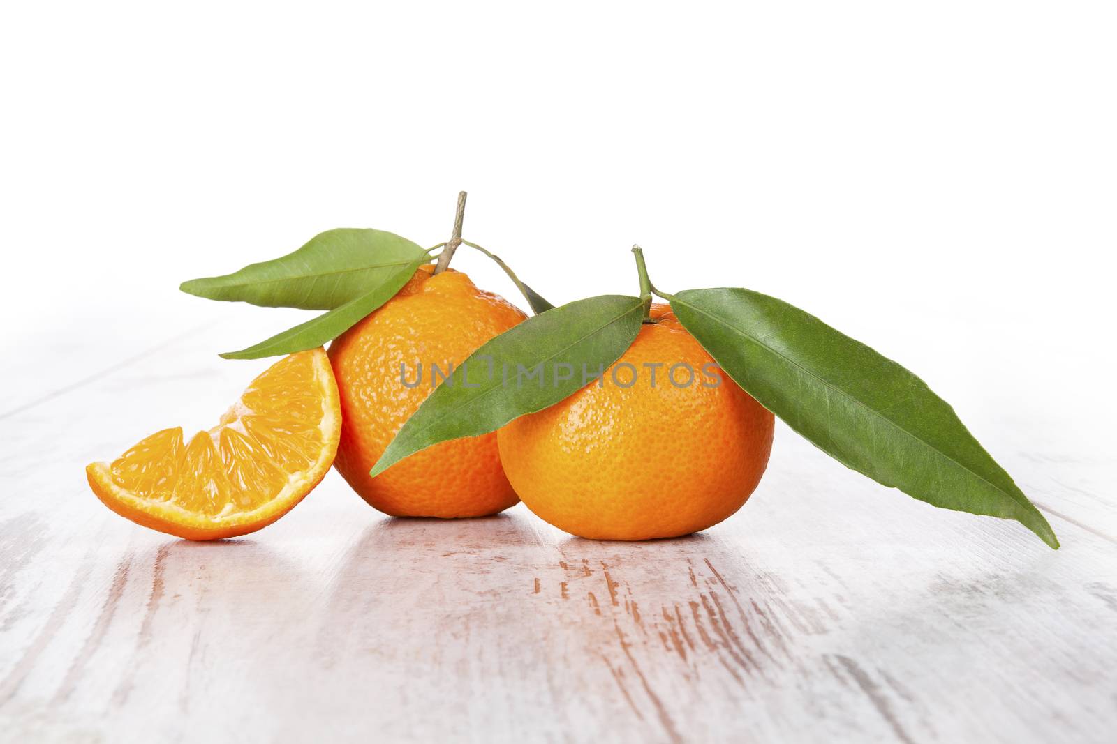 Tangerine on white wooden table. Provence style. by eskymaks