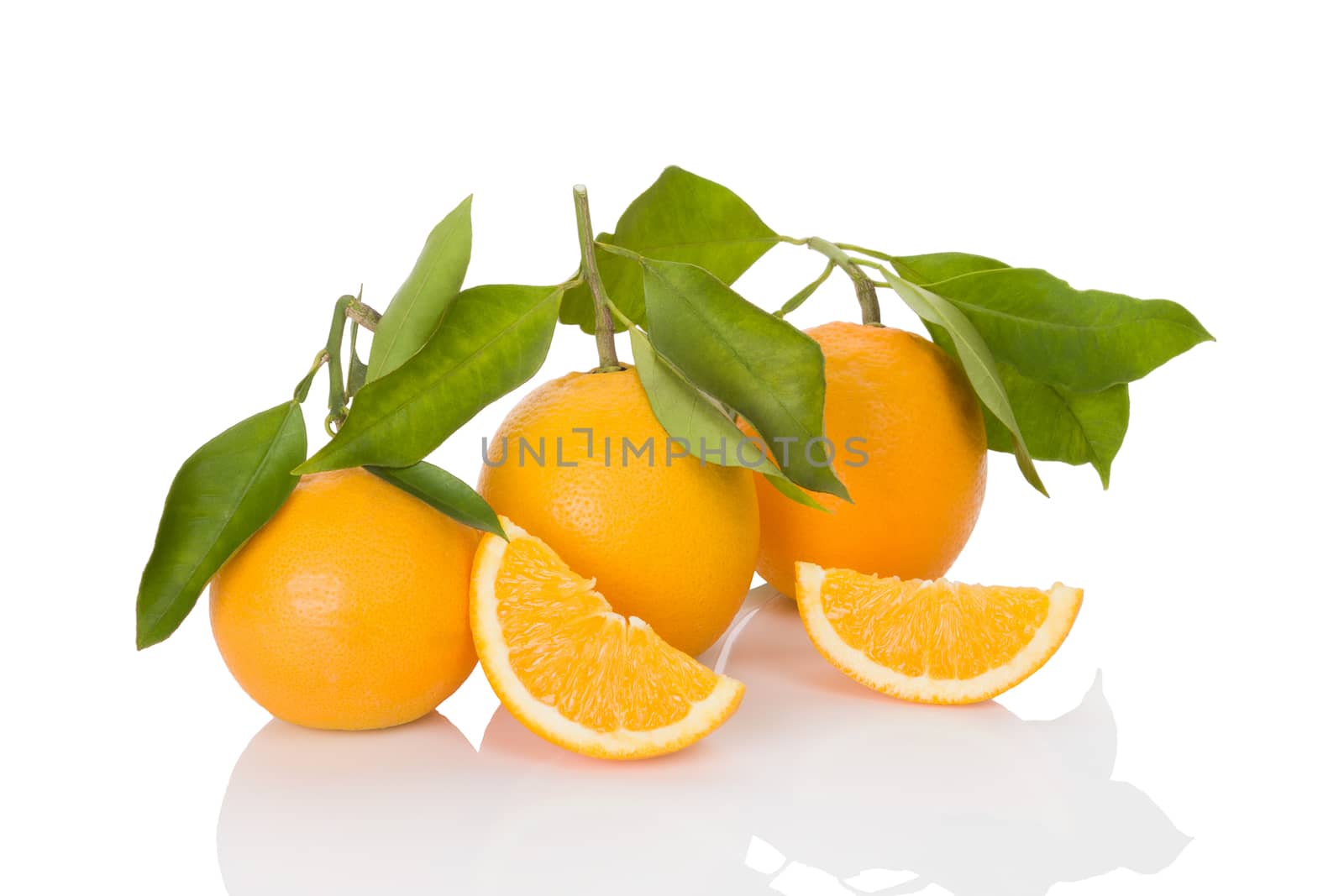 Delicious whole oranges with leaves and slices isolated on white background. Healthy fruit eating. 
