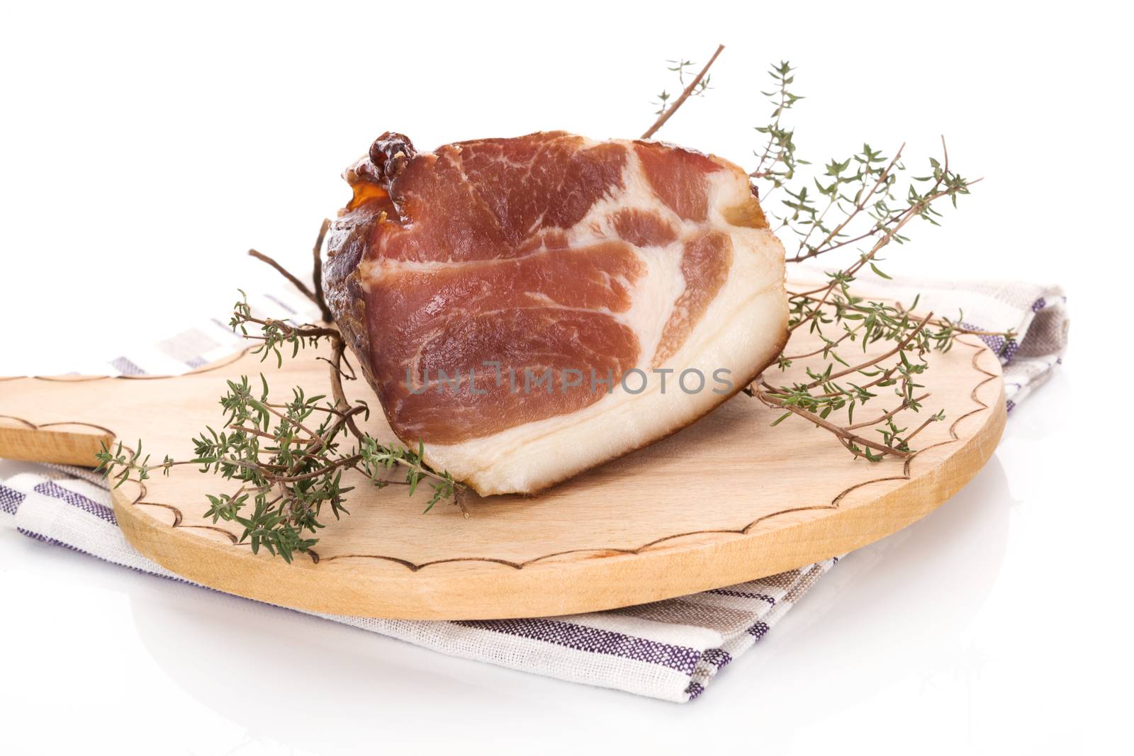 Traditional smoked meat on wooden chopping board isolated on white background. Culinary smoked meat eating. 