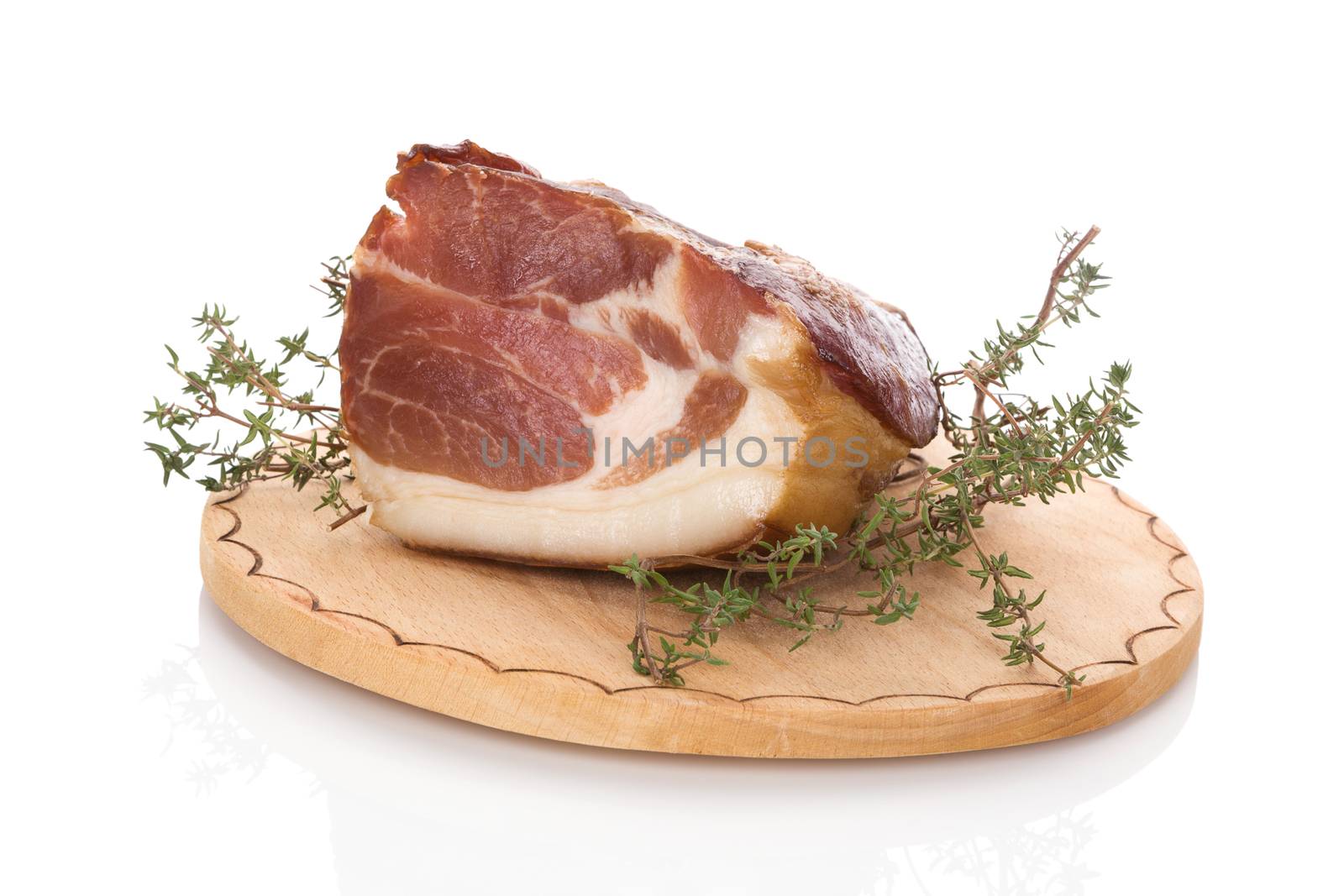 Traditional smoked meat on wooden chopping board isolated on white background. Culinary smoked meat eating. 