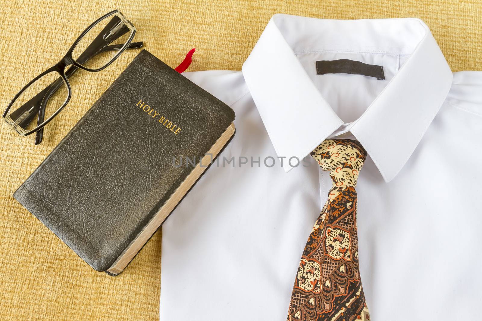 pastos clothes and Holy Bible and glasses at home