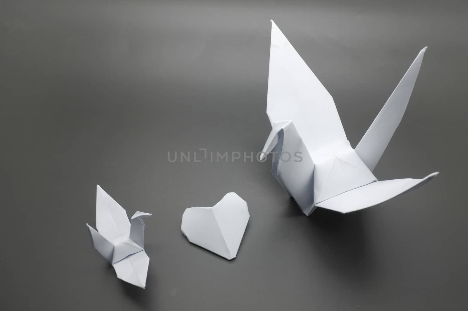 White origami crane and heart between, bird paper by Hepjam