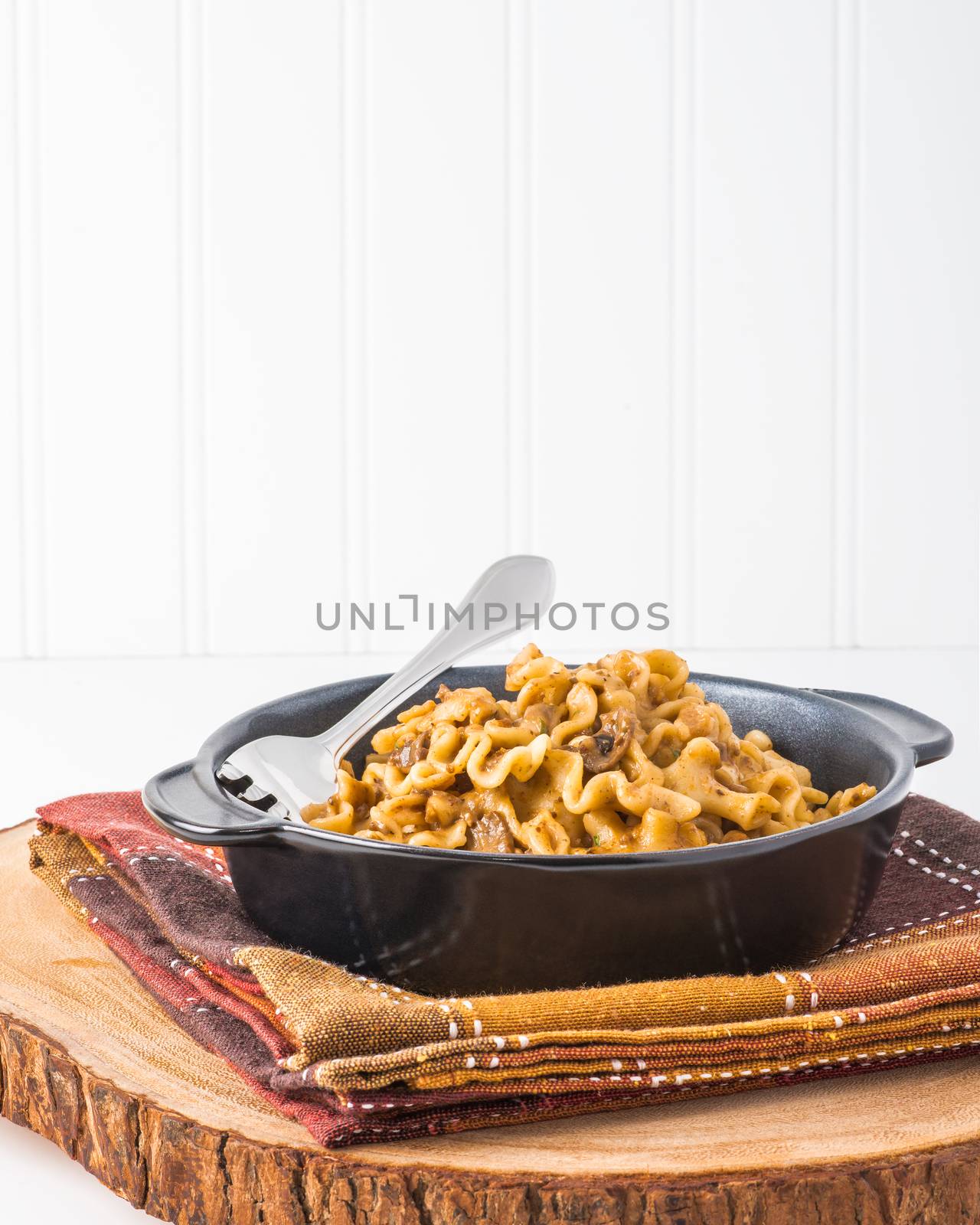 Serving of beef stroganoff photographed in portrait orientation for ample copy space.