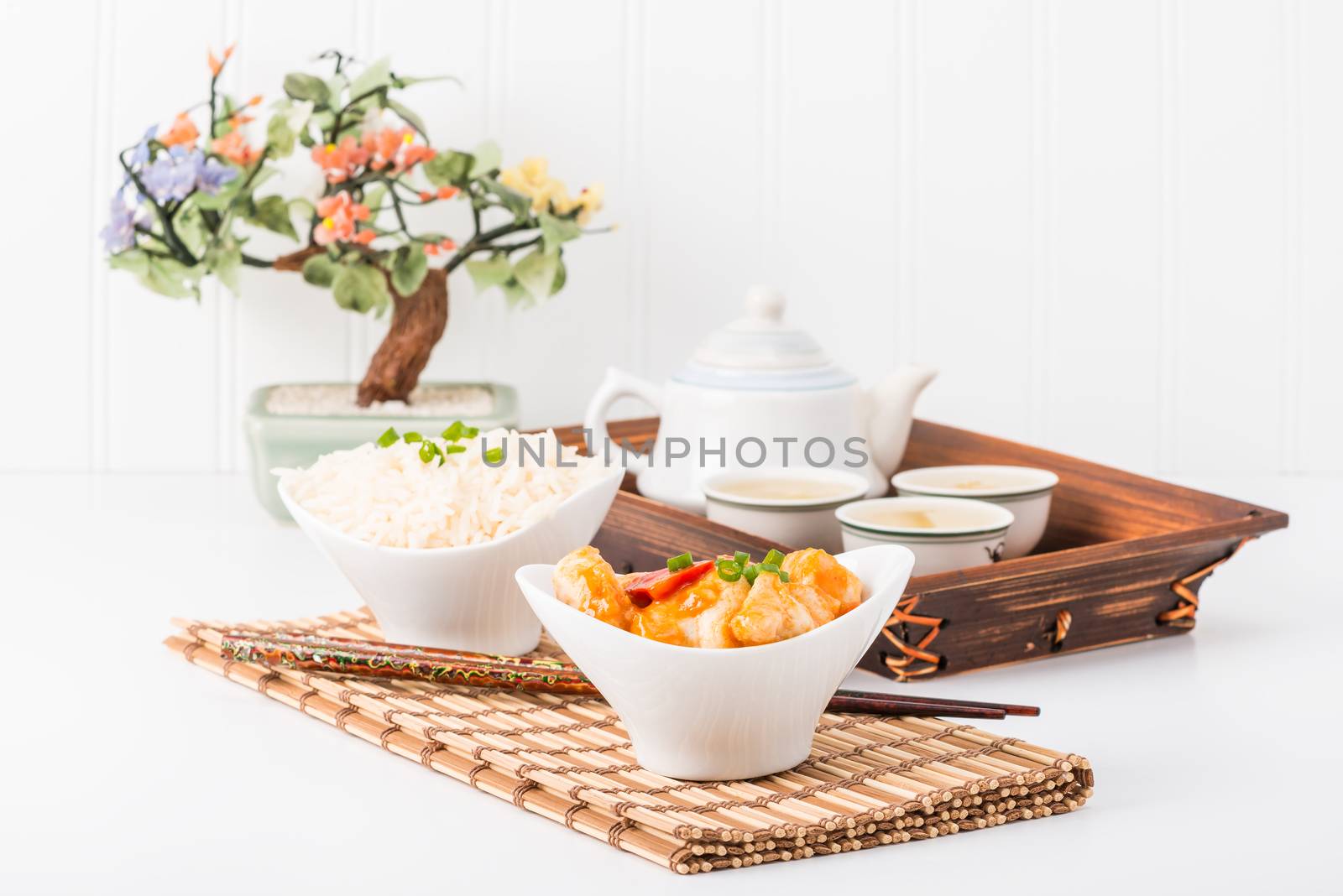 Chicken with a red pepper sauce served with white rice.