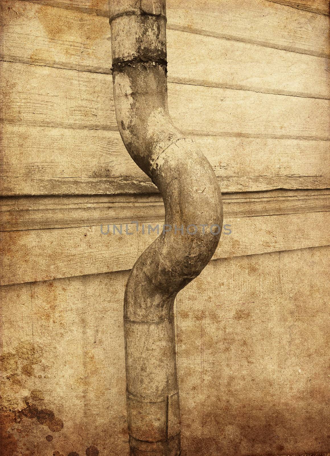 Textured rusty rain pipe against wooden facade pointing right.