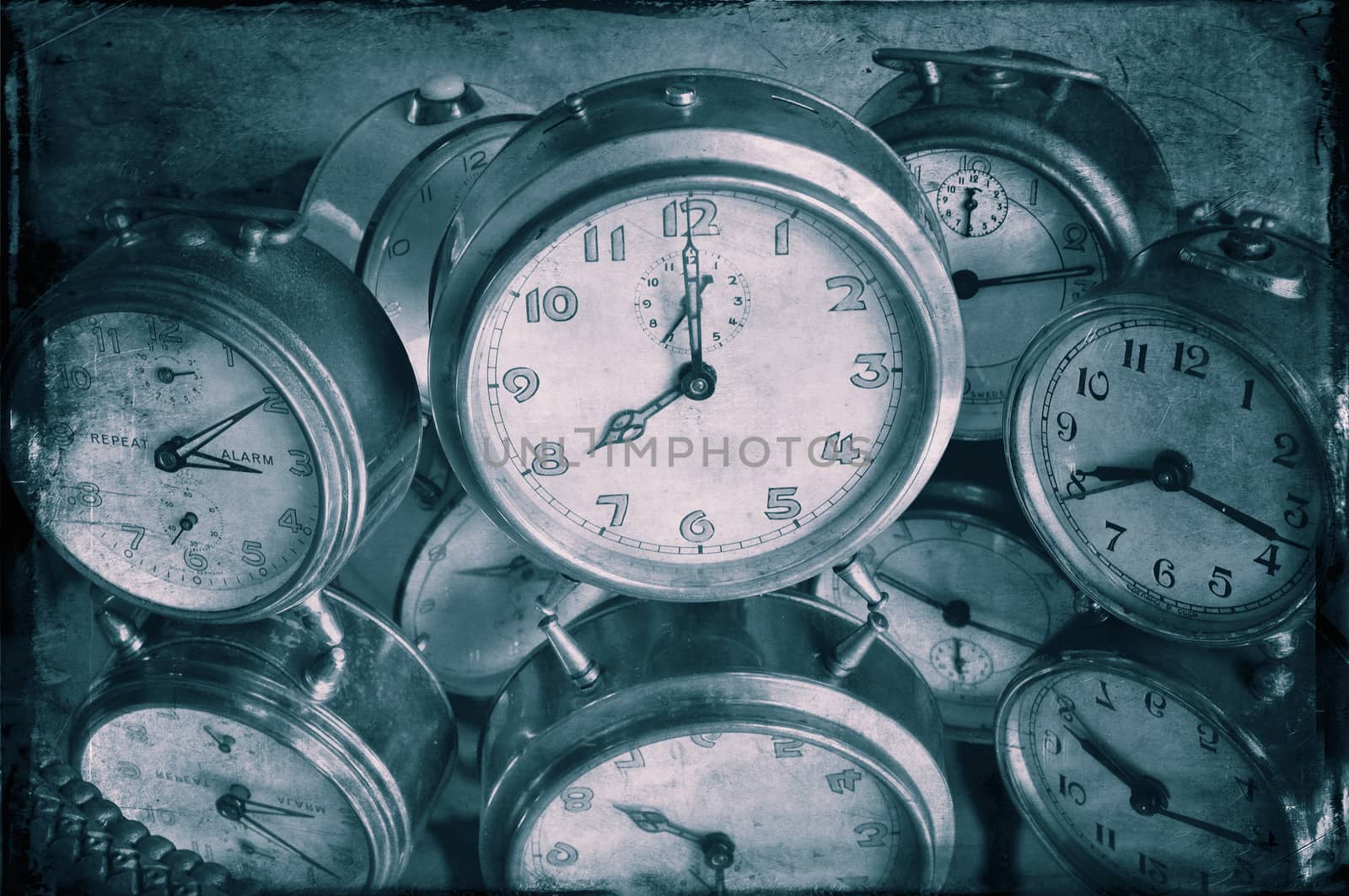 Closeup of textured image of vintage alarm clocks in blue.