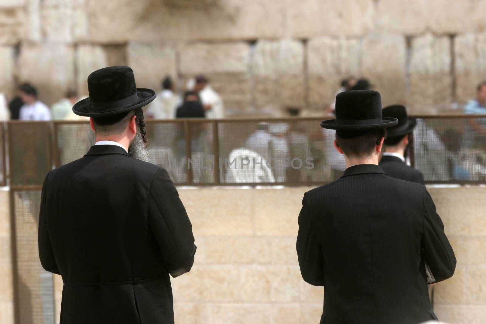 Jewish men pray at the western wall October 03, 2006 in Jerusalem, IL. The wall is one of the holiest sites in Judaism attracting thousands of worshipers daily.