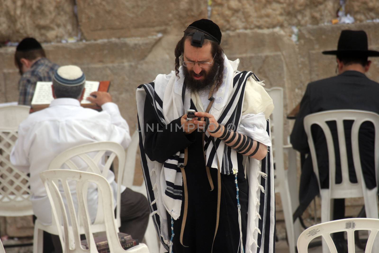 Jewish men pray at the western wall October 03, 2006 in Jerusalem, IL. The wall is one of the holiest sites in Judaism attracting thousands of worshipers daily.