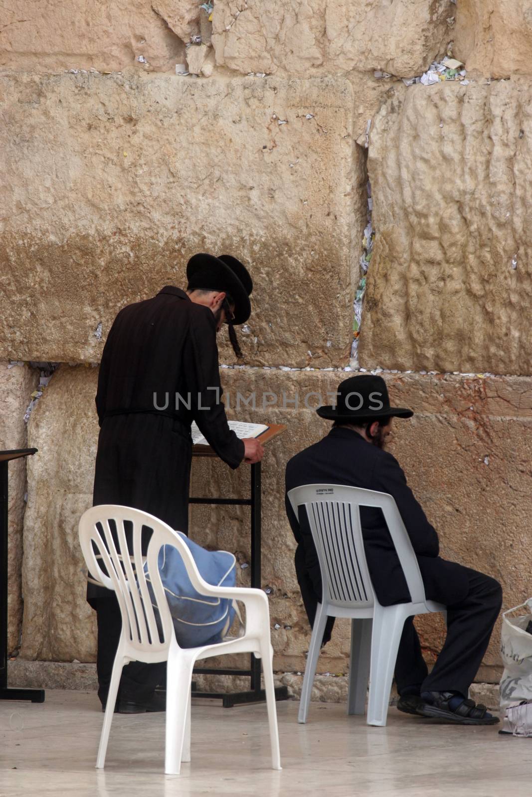 Jewish men pray at the western wall October 03, 2006 in Jerusalem, IL. The wall is one of the holiest sites in Judaism attracting thousands of worshipers daily.