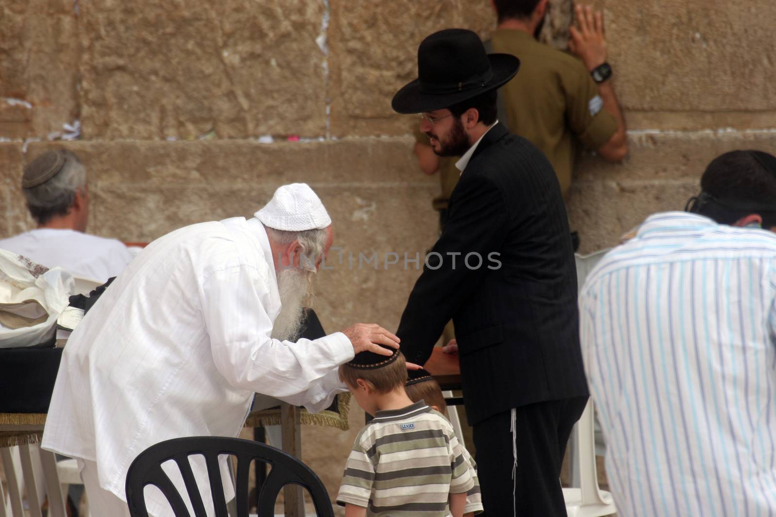 Jewish men pray at the western wall October 03, 2006 in Jerusalem, IL. The wall is one of the holiest sites in Judaism attracting thousands of worshipers daily.