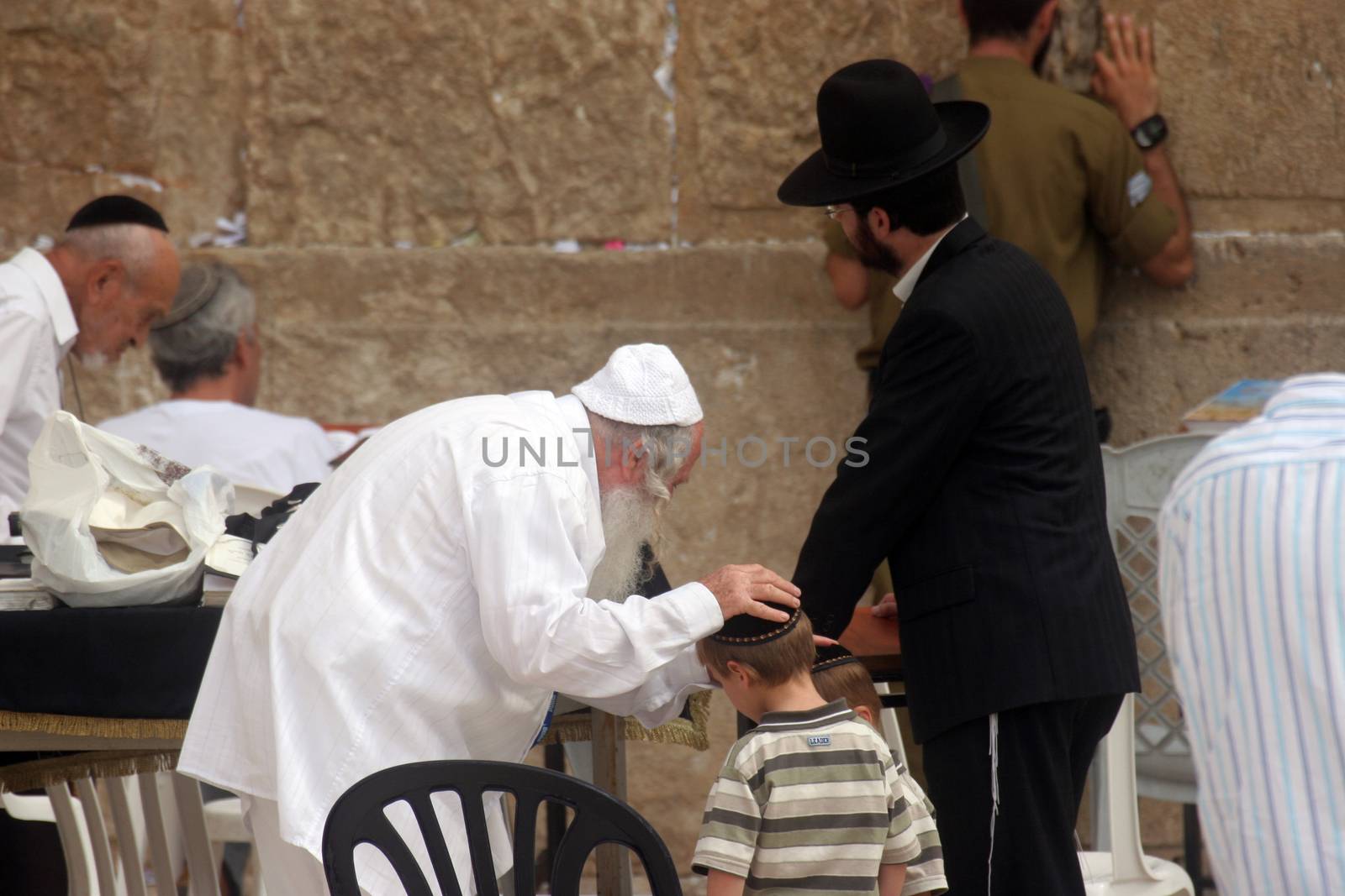 Jewish men pray at the western wall October 03, 2006 in Jerusalem, IL. The wall is one of the holiest sites in Judaism attracting thousands of worshipers daily.