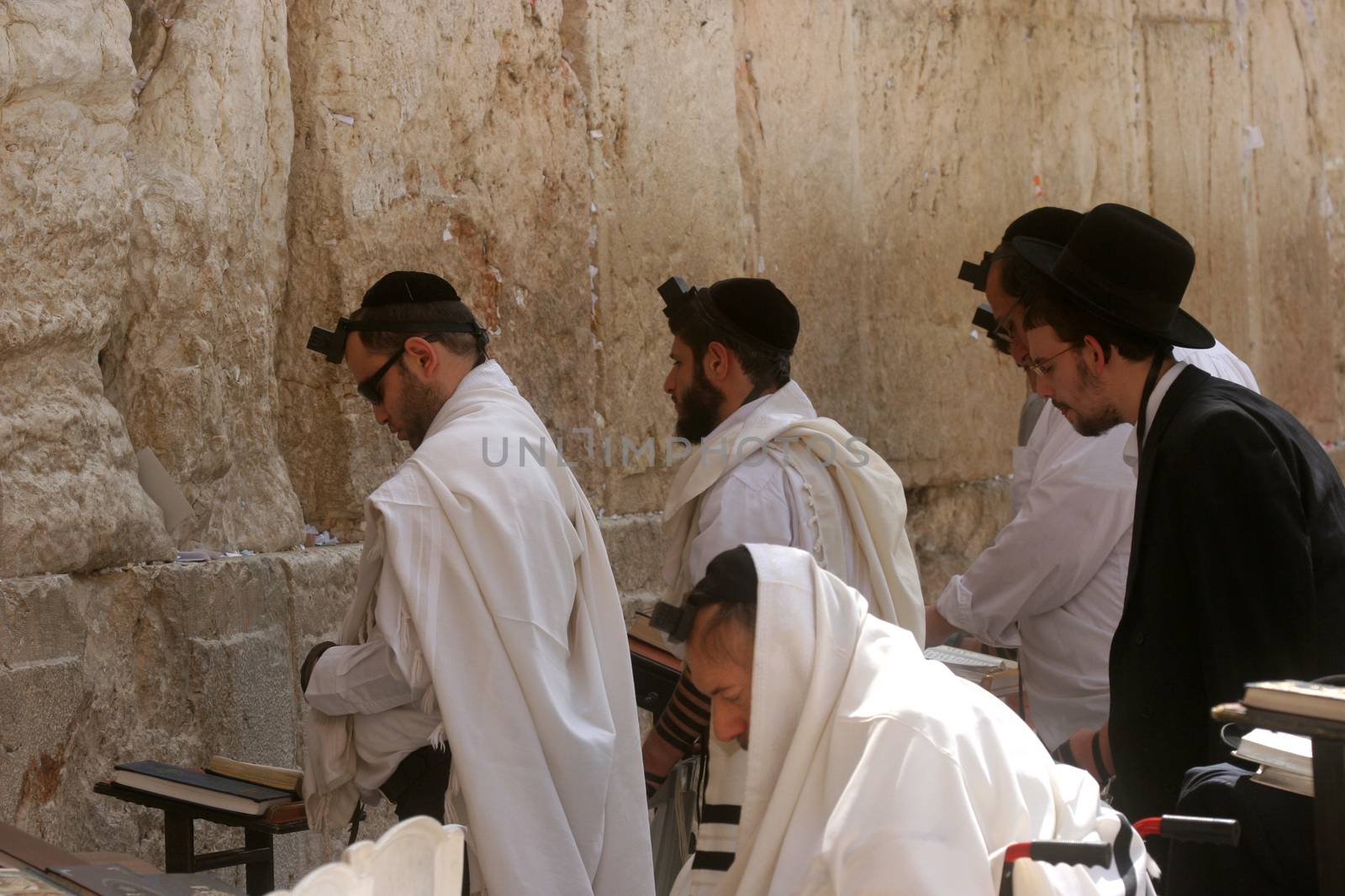 Jewish men pray at the western wall October 03, 2006 in Jerusalem, IL. The wall is one of the holiest sites in Judaism attracting thousands of worshipers daily.