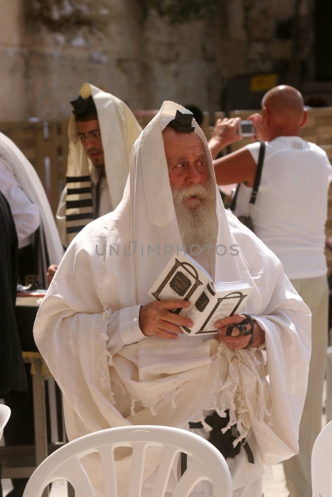 Jewish men pray at the western wall October 03, 2006 in Jerusalem, IL. The wall is one of the holiest sites in Judaism attracting thousands of worshipers daily.