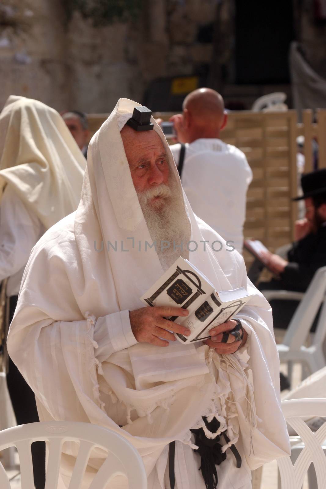 Jewish men pray at the western wall October 03, 2006 in Jerusalem, IL. The wall is one of the holiest sites in Judaism attracting thousands of worshipers daily.
