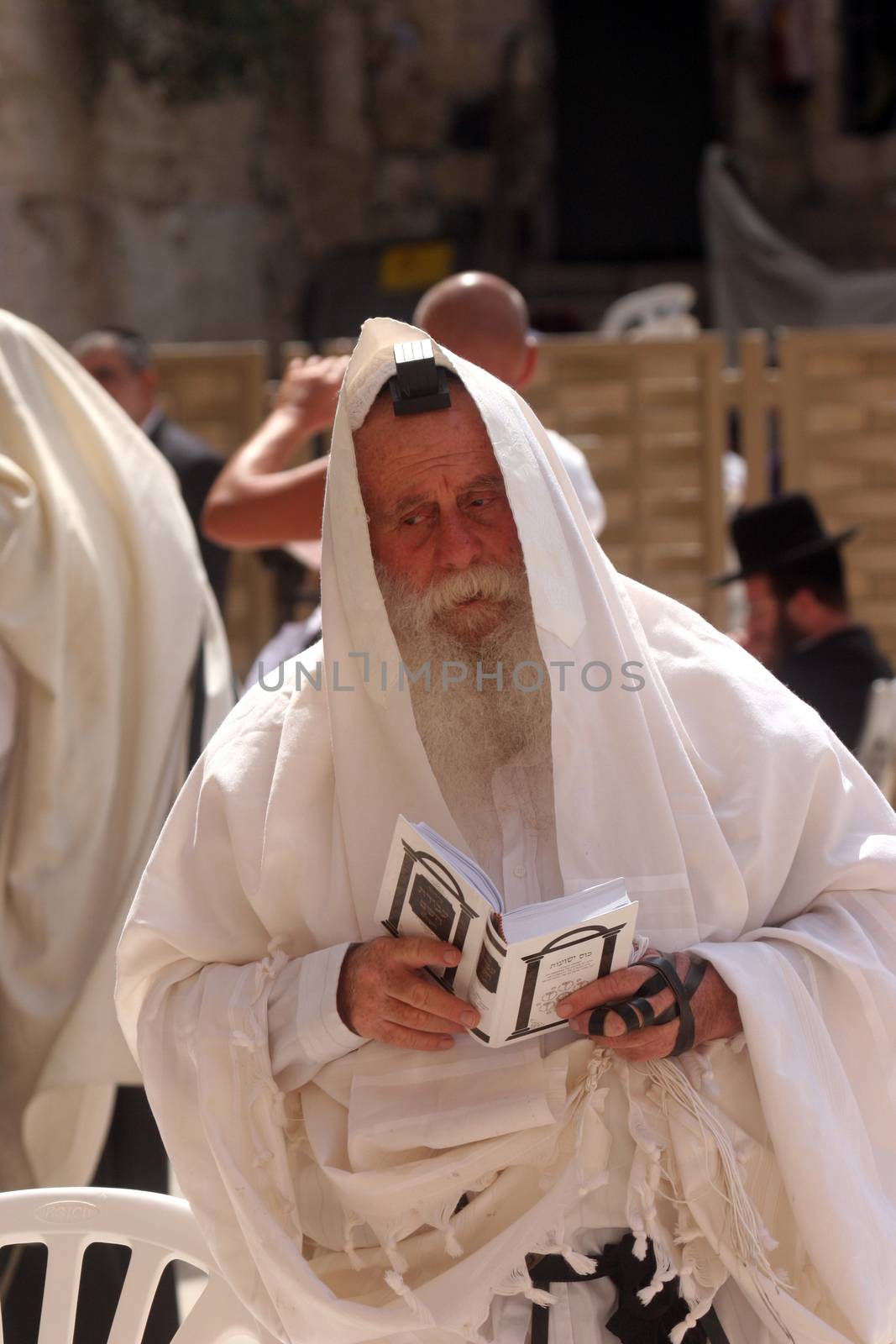 Jewish men pray at the western wall October 03, 2006 in Jerusalem, IL. The wall is one of the holiest sites in Judaism attracting thousands of worshipers daily.