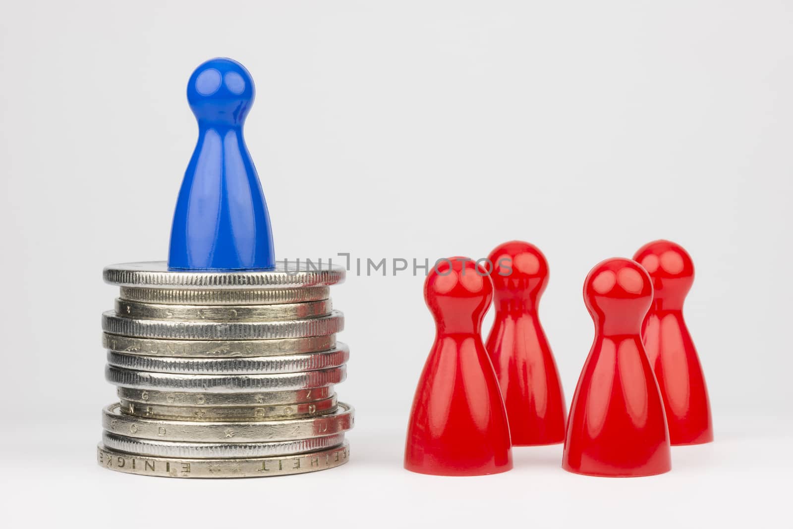 Conceptual financial position represented with colored play pieces and coins
