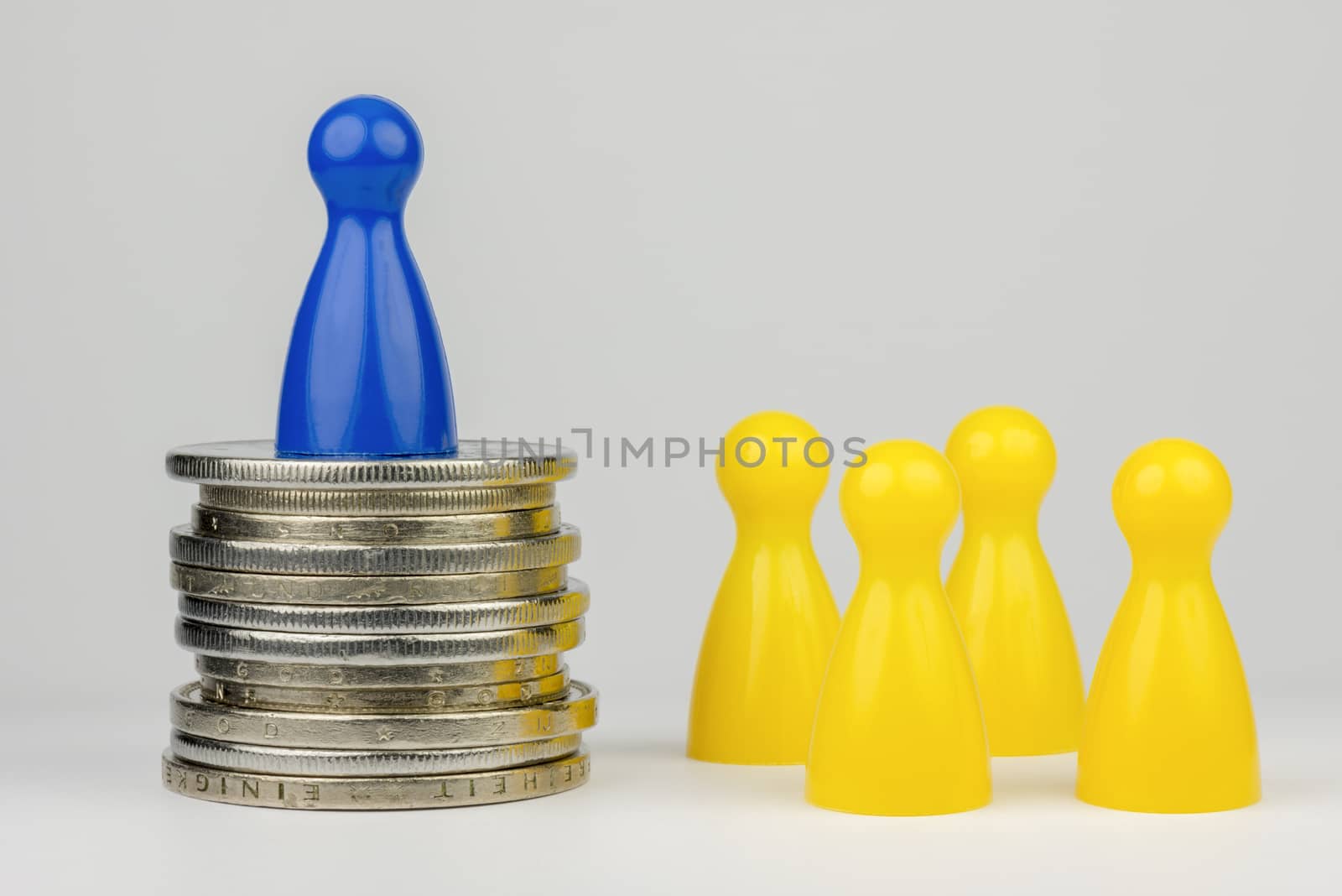 Conceptual financial position represented with colored play pieces and coins
