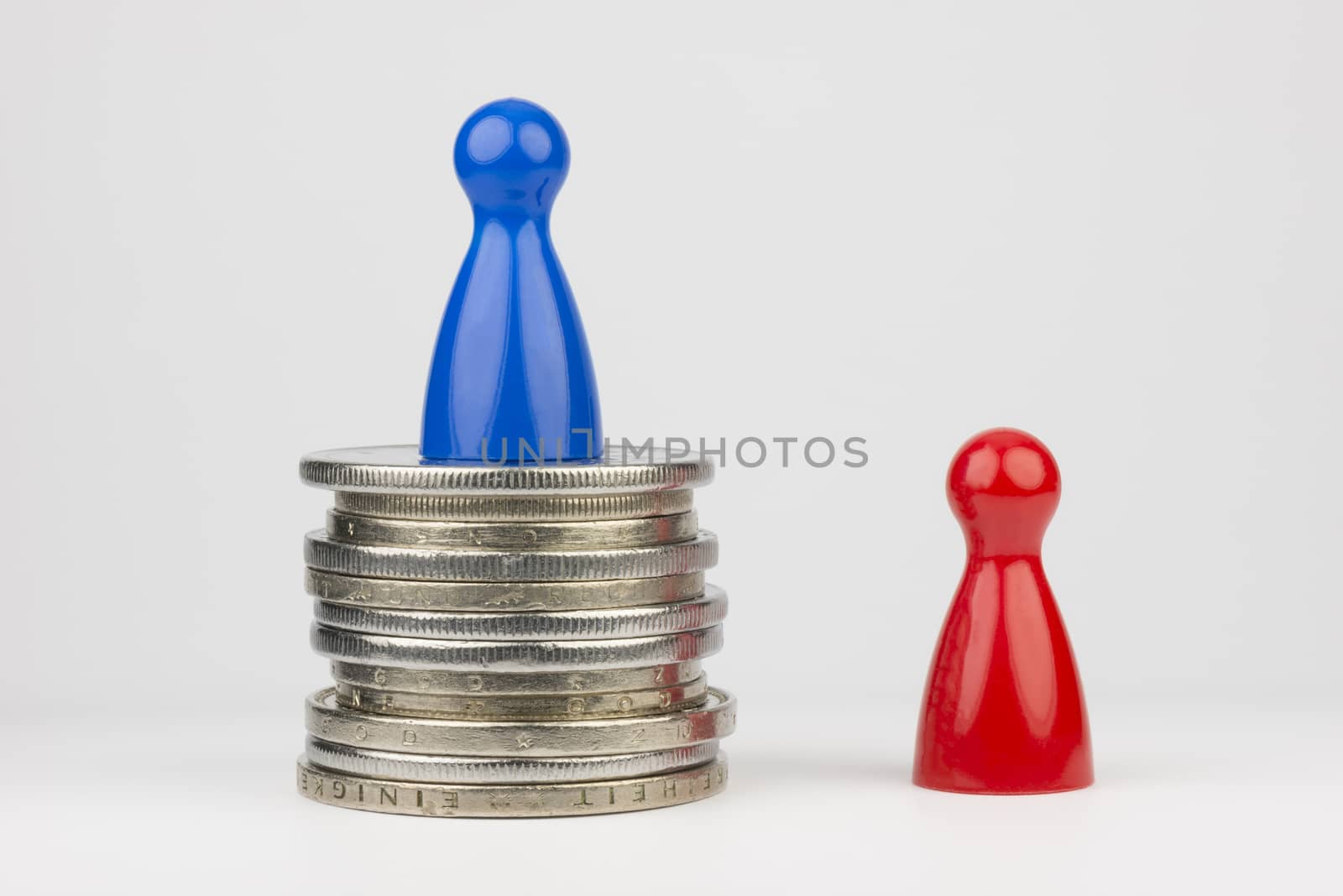 Conceptual financial position represented with colored play pieces and coins
