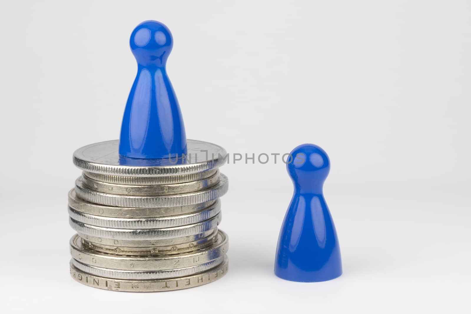 Conceptual financial position represented with colored play pieces and coins
