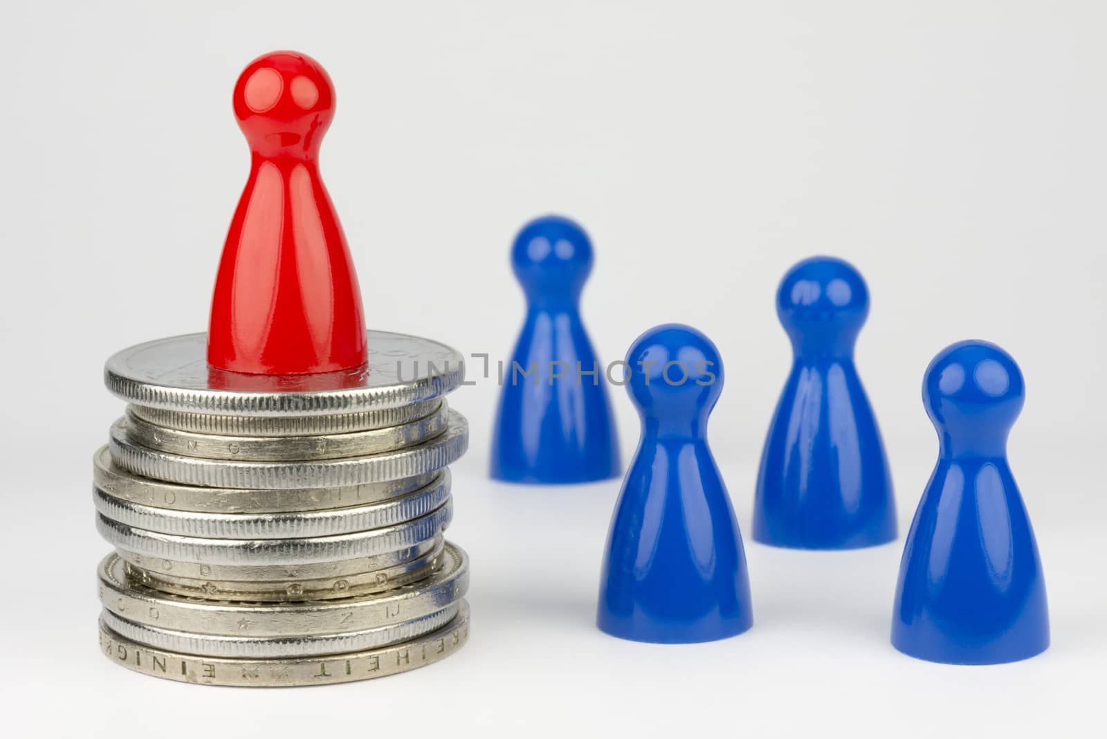 Conceptual financial position represented with colored play pieces and coins
