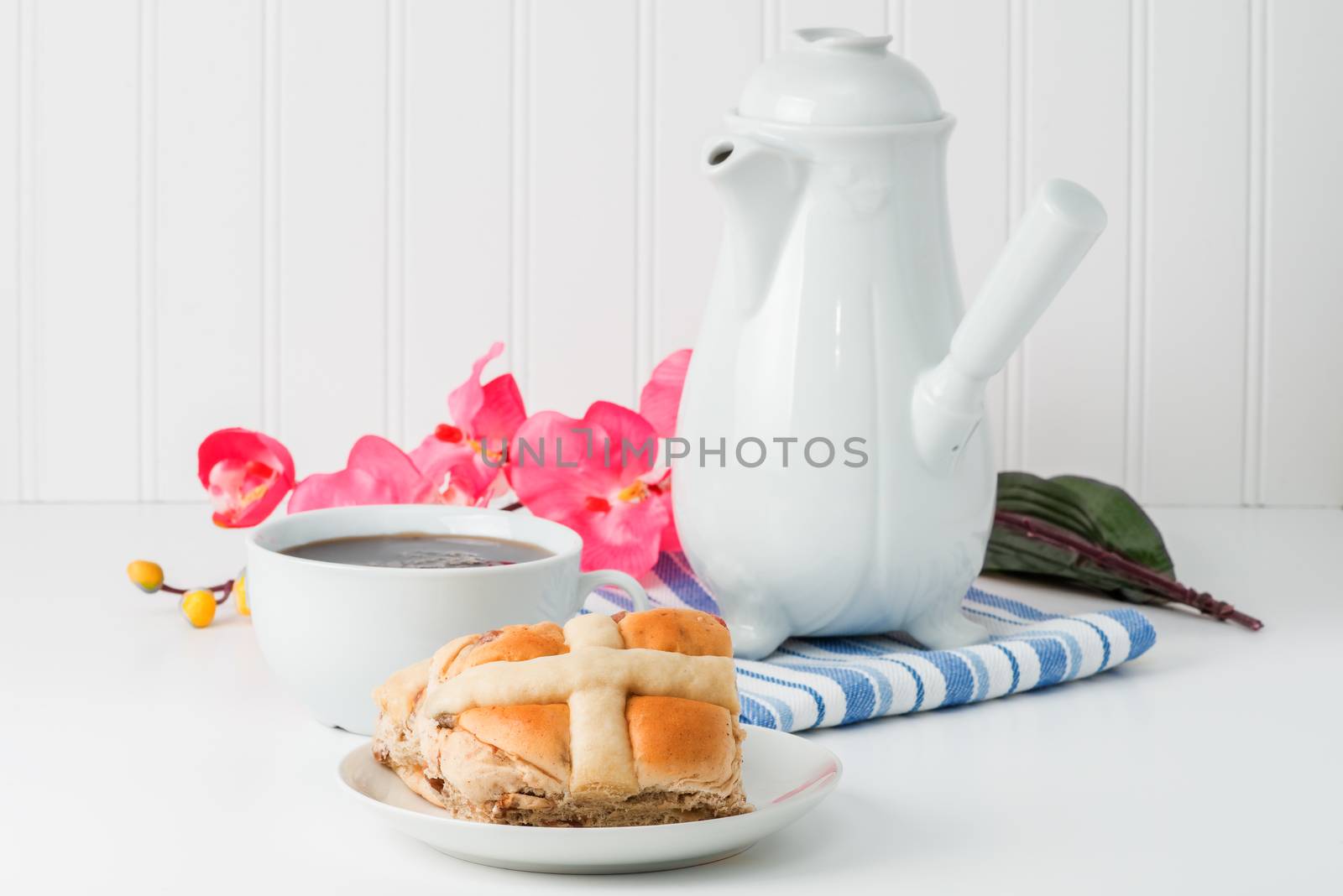 Traditional hot cross bun served with hot tea.