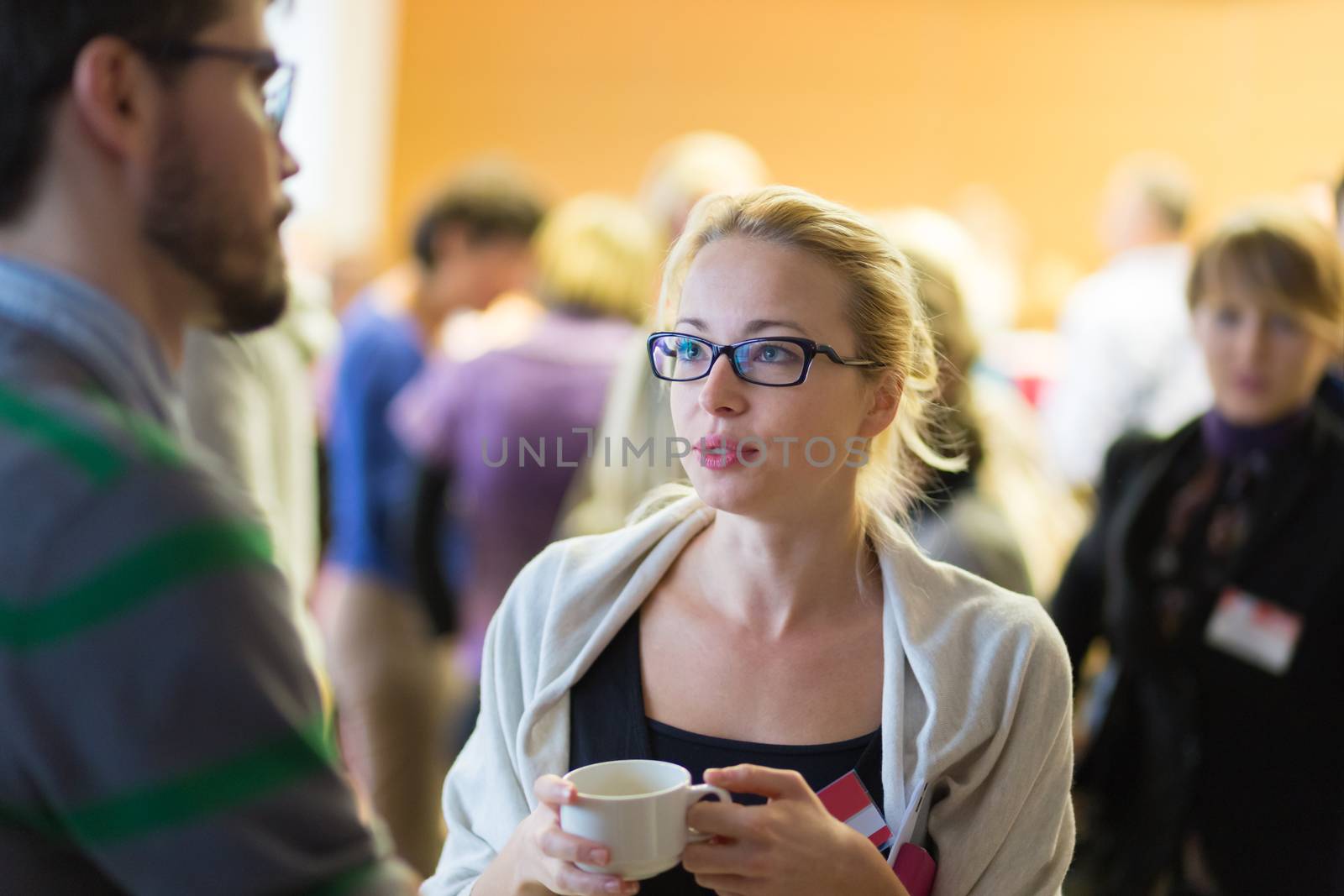 Peoplegathering and socializing during coffee break at conference meeting.  Business and entrepreneurship.