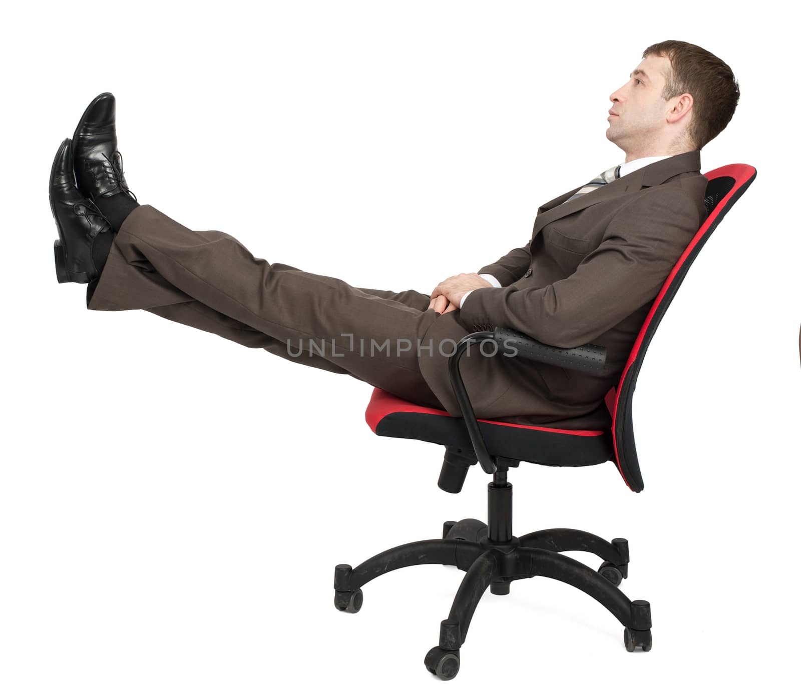 Businessman sitting on chair with legs up isolated on white background, side view