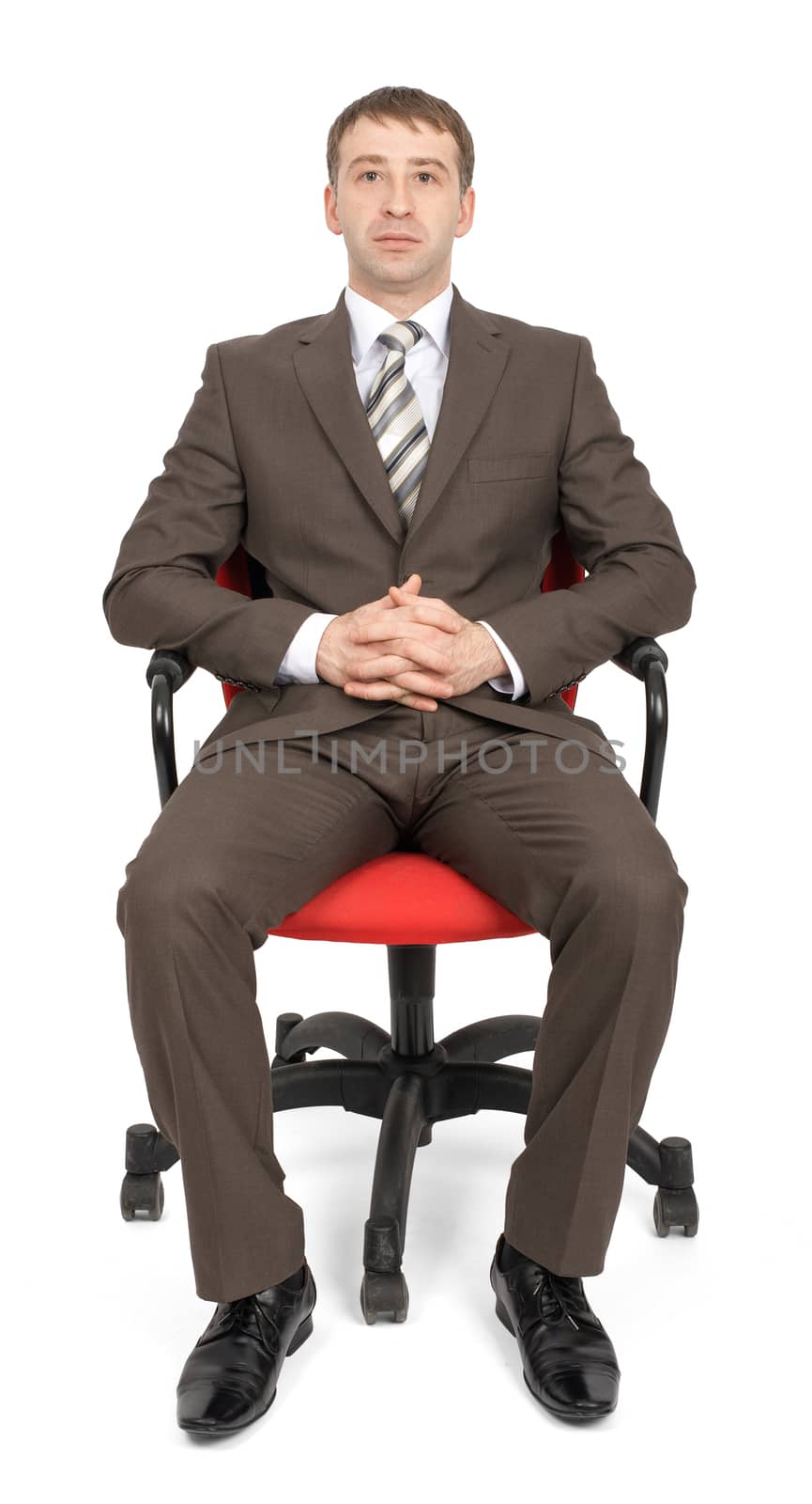 Businessman sitting on chair and looking at camera isolated on white background