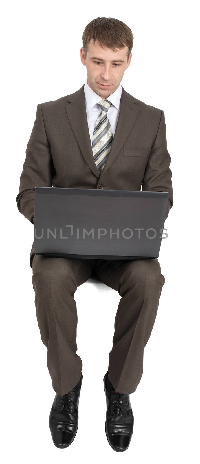 Businessman sitting on empty space with laptop isolated on white background