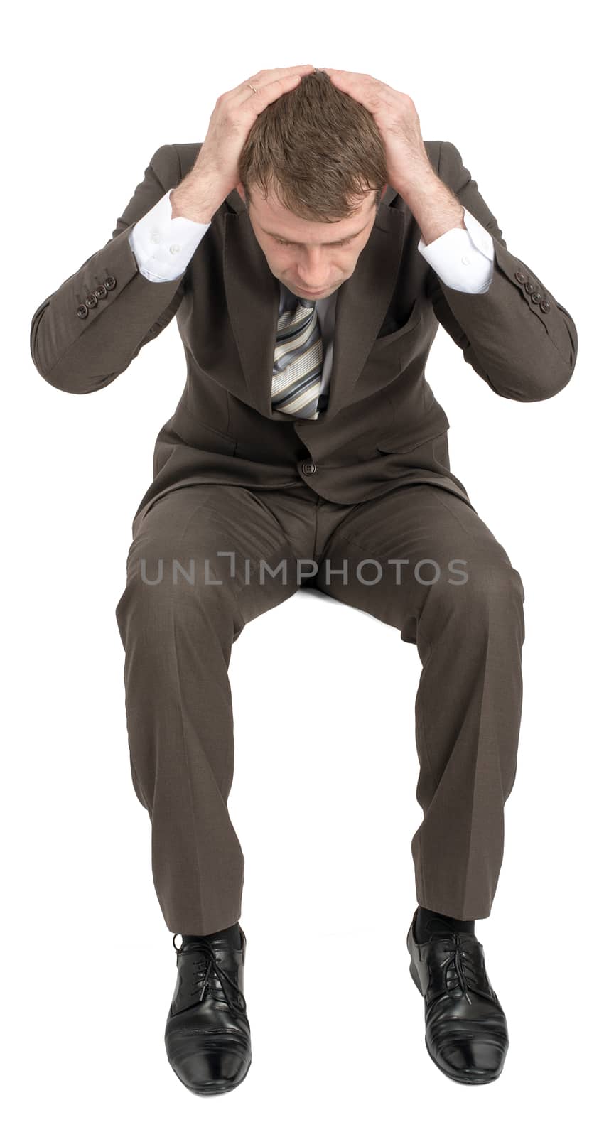 Confused businessman sitting on empty space isolated on white background