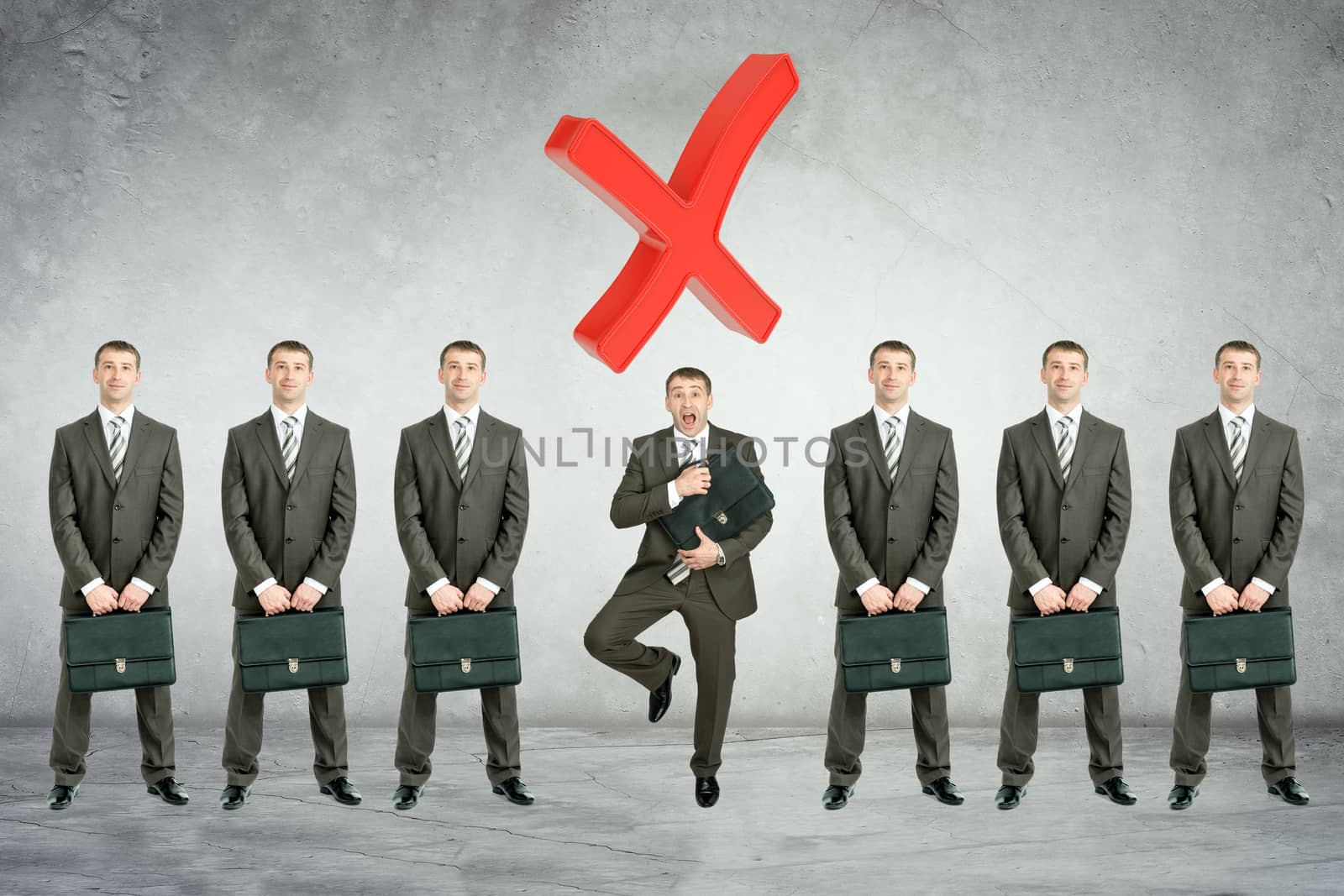 Set of businessmen with big cross on grey wall background
