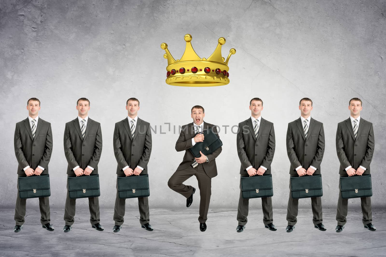 Set of businessmen with big crown on grey wall background