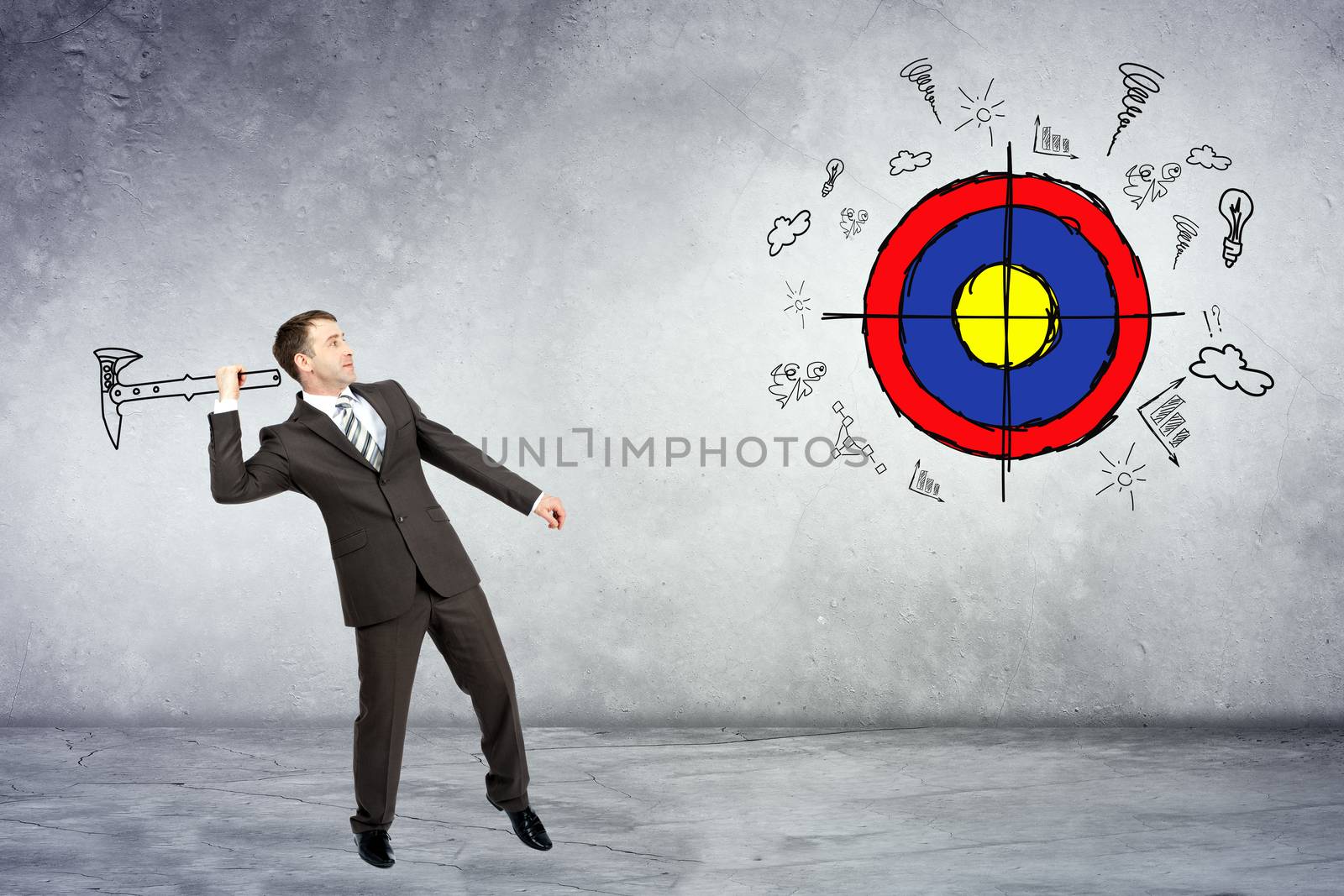 Businessman throwing axe to darts on grey wall background