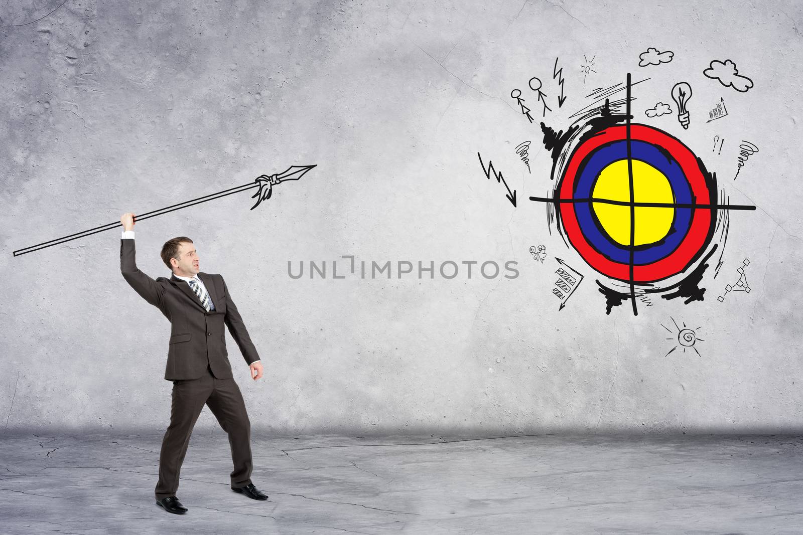 Businessman throwing spear to darts on grey wall background
