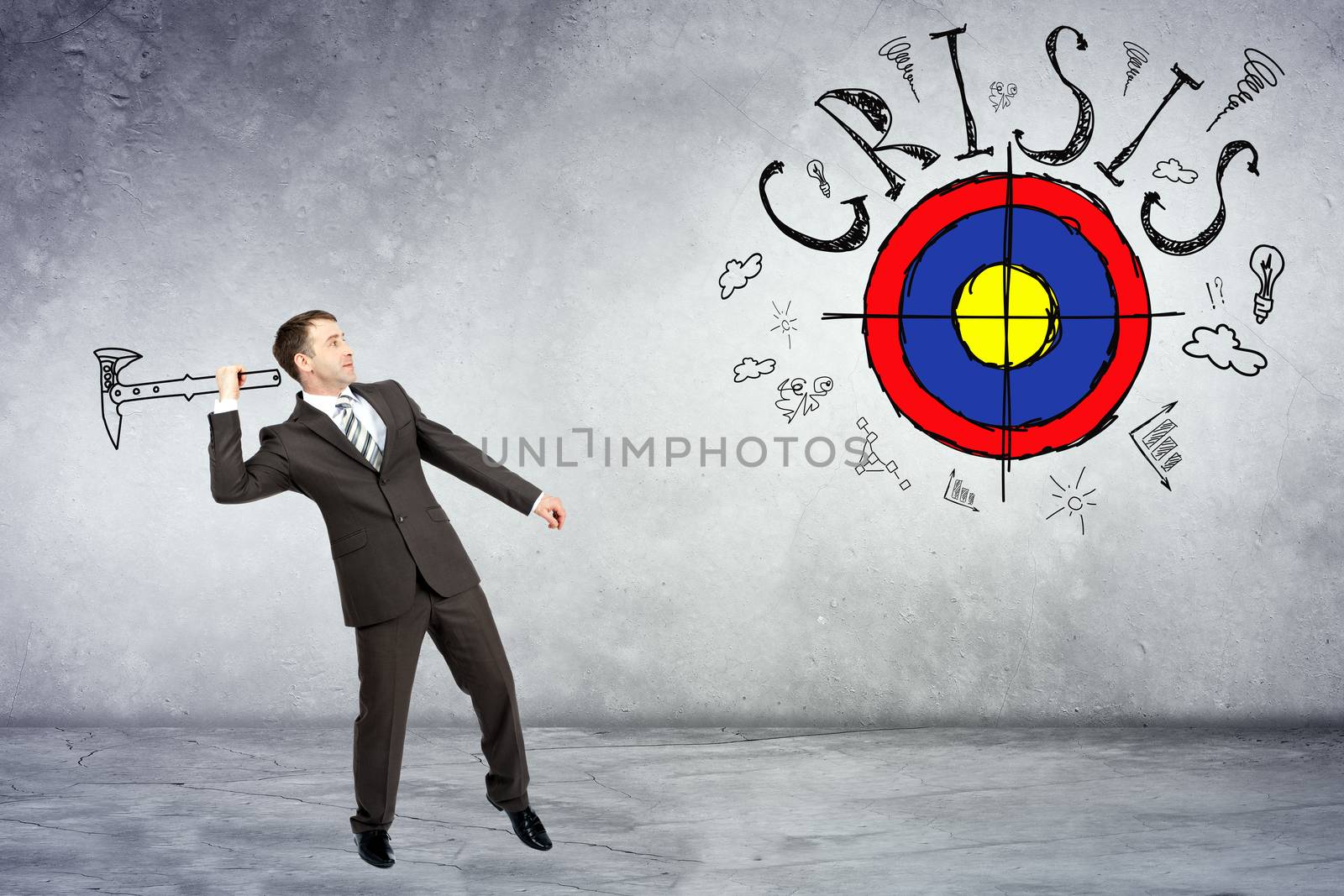 Businessman throwing axe to darts with word crisis on grey wall background