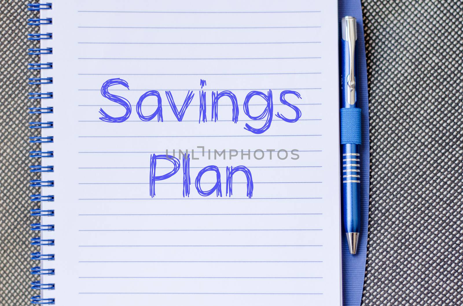 Savings plan text concept write on notebook with pen