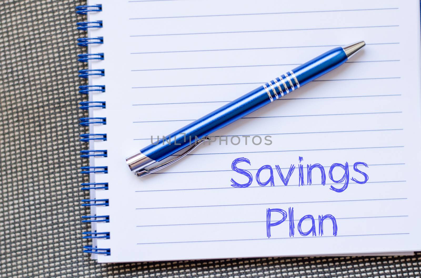 Savings plan text concept write on notebook with pen