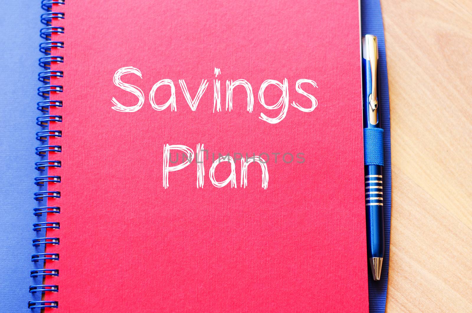 Savings plan text concept write on notebook with pen