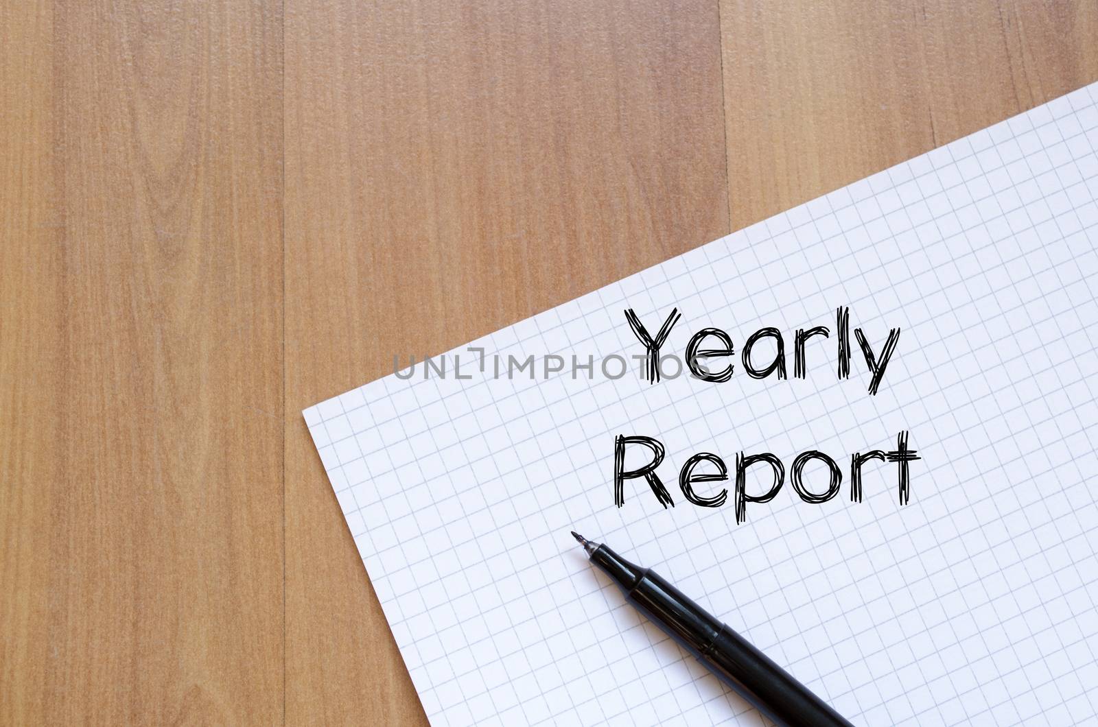 Yearly report text concept write on notebook with pen